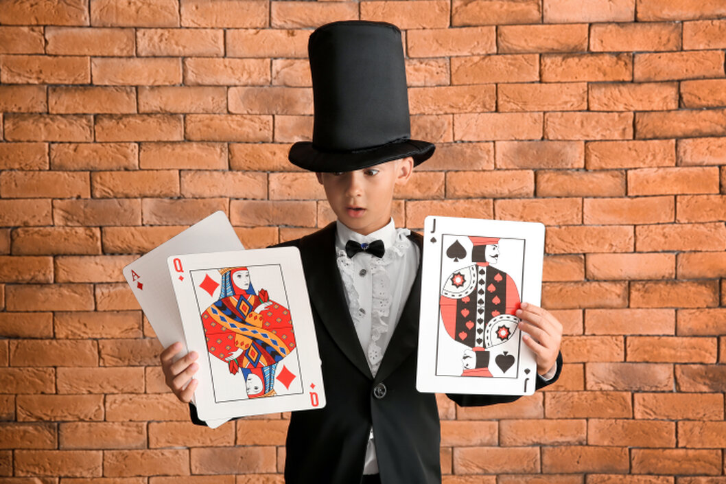 Birthday child helping the magician on stage during a trick