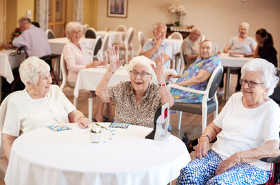 Family-friendly magician performing for seniors at a care facility